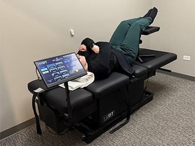 Patient receiving chiropractic adjustment on specialized table at South Suburban Chiropractic Clinic.